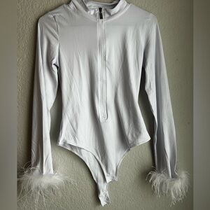 L white body suit with feather cuffs